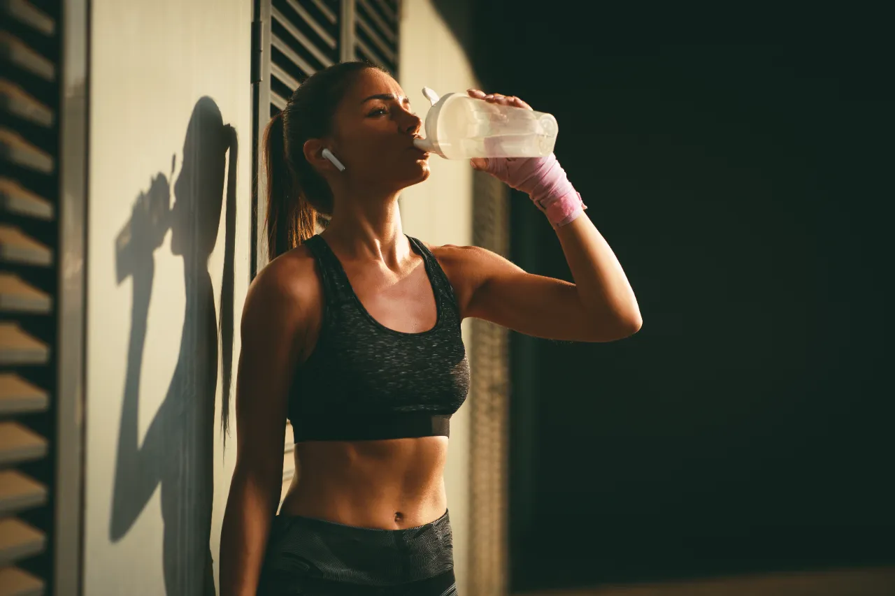 young woman resting after jogging and drink water utc